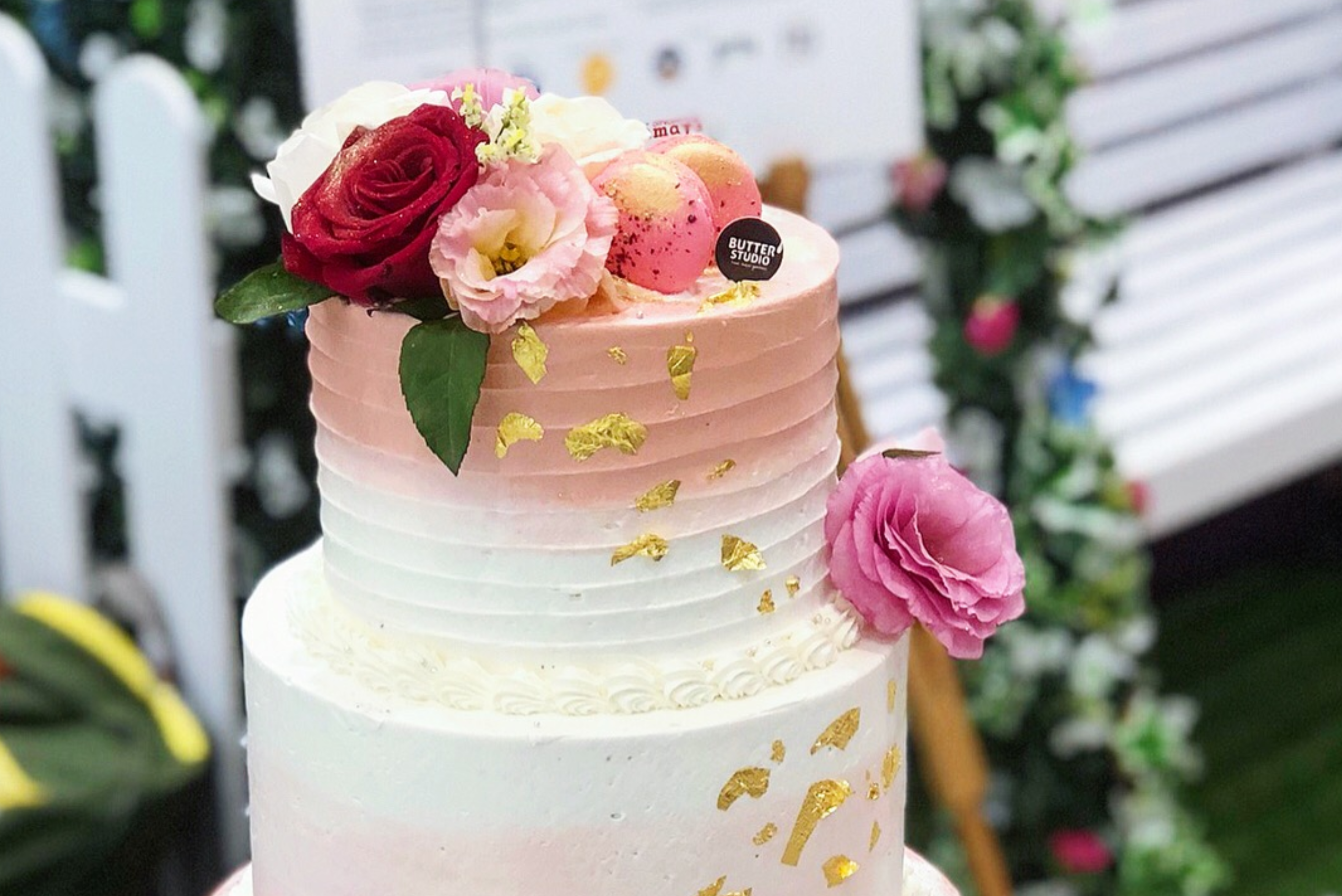 a cake decorated with bees and daisies on a plate